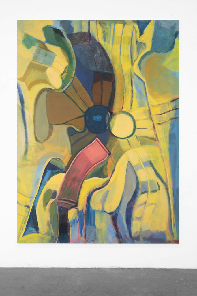 6-foot-tall, 4.5-foot wide painting of the top part of a baseball cap. The painting is mostly yellow with two buttons in the center, one yellow, one dark blue, and a pink rectangle directly below it.